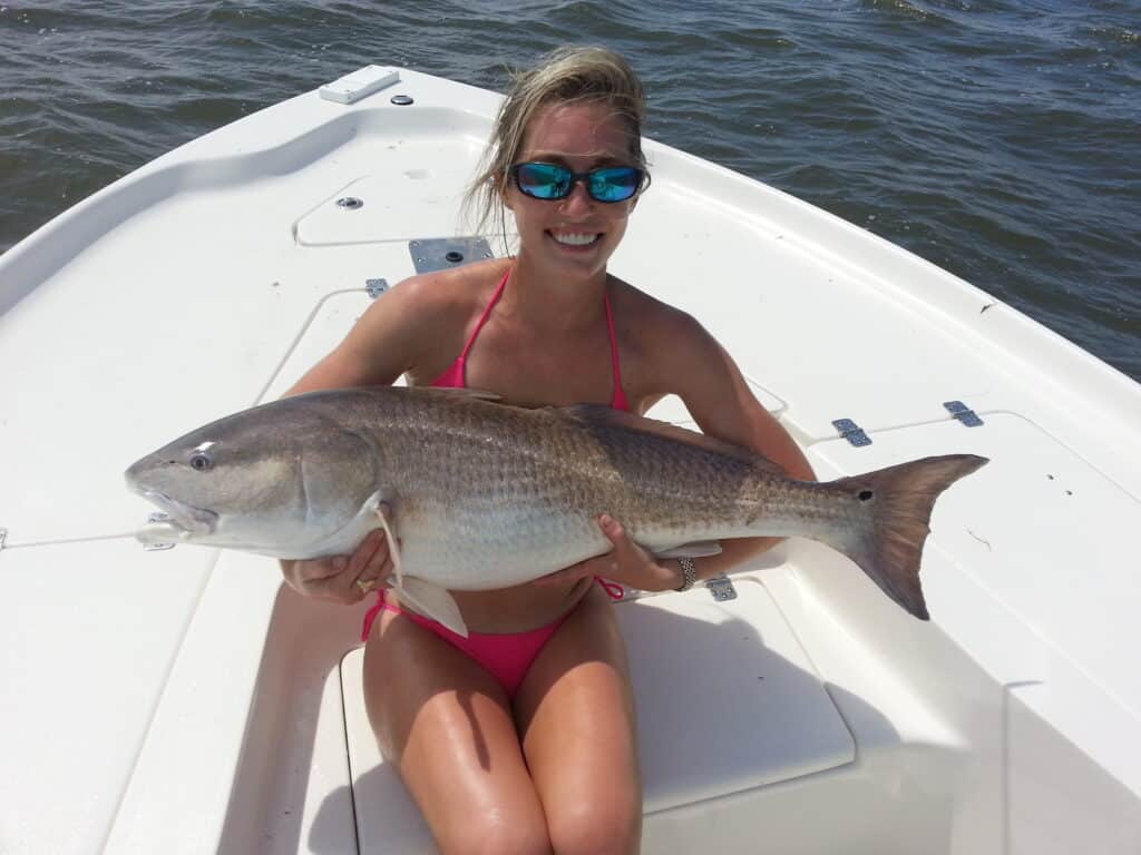 woman holding red drum in myrtle beach, south carolina