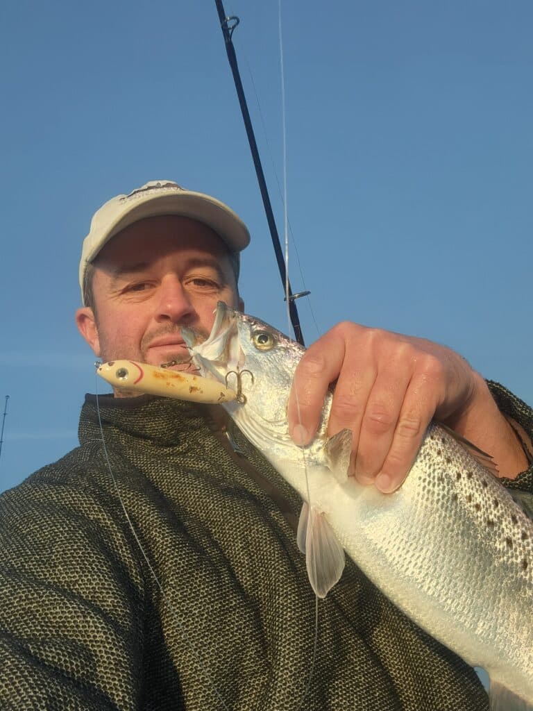Charter Captain holding spotted seatrout in myrtle beach, sc